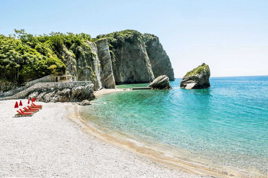 The beach and the cliffs on the island of St. Nicholas in Budva, Montenegro